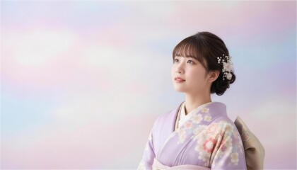 淡い背景で見上げる紫の振袖姿の日本人女性