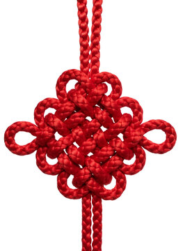 Close-up photograph of a intricately knotted, bright red Chinese knot