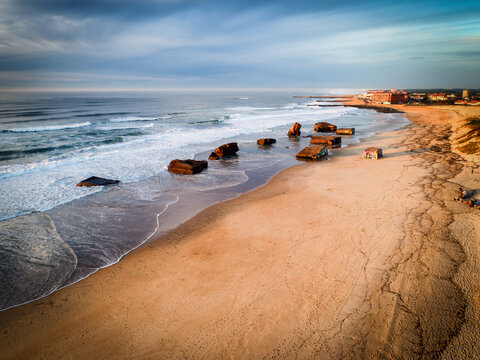 Aerial view of the stark contrast between the beach and the Atlantic ocean, with remnants of the bunkers from World War II adding a textured layer, Capbreton, France.