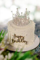 A birthday cake topped with a crown, pearls, and a 'Happy Birthday' message. Perfect for a celebration, it is a delightful and elegant treat for the special day. © photo for everything