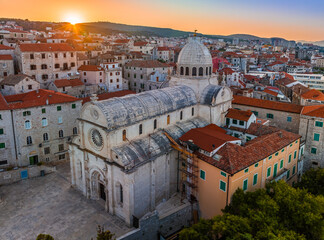 Sibenik, Croatia - Aerial view of the mediterranean old town of Sibenik on a sunny summer morning with Saint James Cathedral, Fortress of Saint Michael and dramatic golden sunrise by the Adriatic sea