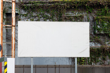 Large blank billboard on a street wall, banners with room to add your own text