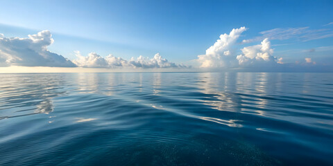 Calm Ocean Surface with Blue Sky and Clouds
