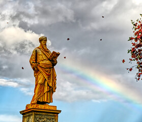 A fall Sean of Saint Paul in Rome with falling leaves and a rainbow touching him.
