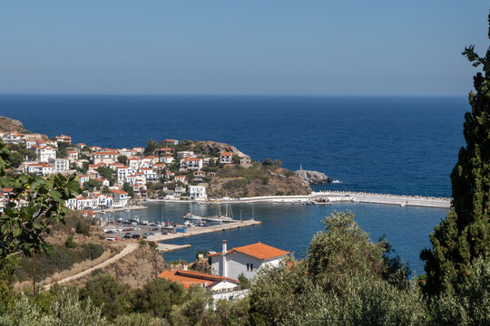 Agios Kirykos harbor and coastline, Ikaria island, Greece.Elevated view of Agios Kirykos harbor and coastline on Ikaria island, Greece, showing the village, marina and deep blue Aegean Sea. Travel and