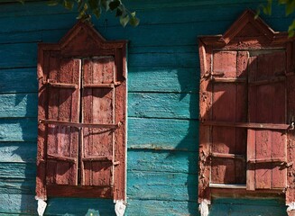 Close-up shot of closed shutters on old wooden house.