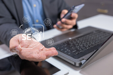 A person holds a globe in one hand while using a smartphone, surrounded by icons symbolizing SEO and digital marketing.