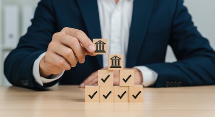 Businessman placing bank icon on blocks