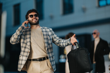 Fototapeta premium Two stock sentences: A business man on the phone, wearing a plaid blazer and beige outfit, holds a black bag. He gestures with his free hand in a sunny city street scene.