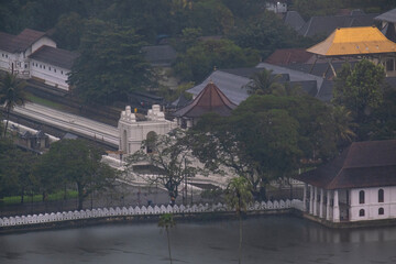 A view of the city of Kandy from the opposite shore of Lake Kandy, Sri Lanka. A historic Buddhist temple with a relic is located in this city. The rain begins during Hurricane Dilwa.