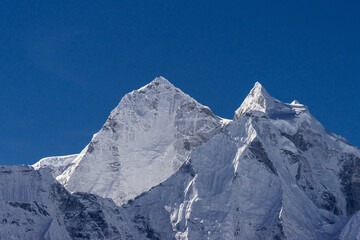 Kangtega and Thamserku peaks under blue sky. View from Thukla (Dughla) on Everest base camp trekking, Nepal.