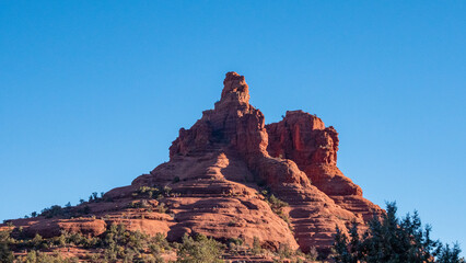 View of the majestic red rock formation rises against the clear blue sky, a testament to nature's artistry, Desert Hills, Arizona, United States.