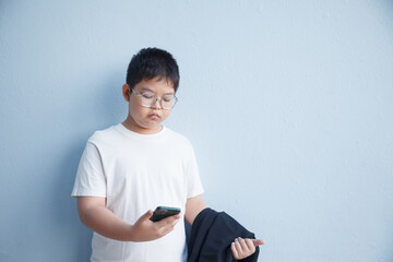 The boy stared at his smartphone with a serious expression.