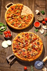 Tasty pizza with dry smoked sausages, olives, pepper