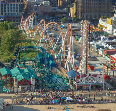 Aerial view of the thrilling Thunderbolt roller coaster cuts through the cityscape, a modern marvel amid the classic Coney Island skyline, Brooklyn, New York, United States.