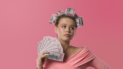 A woman in a pink blouse, with curlers in the shape of banknotes in her hair, stands against a pink background, holding a fan made of banknotes and looking very upset.