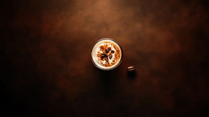 Delicious latte art with coffee beans on top served in a glass on a wooden surface
