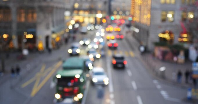 Blurred city street at night with traffic lights creating a bokeh effect and moody atmosphere. Wide angle, real time video