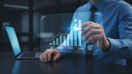 Businessman analyzing financial growth and data trends for 2025 with futuristic digital holographic bar charts and graphs on laptop screen in modern office corporate setting.
