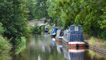 The Llangollen canal at Wrenbury close to Whitchurch with narrow boats moored and a bridge