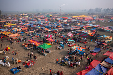 Bogura, Bangladesh - 10 February 2021: Aerial view of the bustling Hathibandha haat, a vibrant tapestry of colorful stalls and lively commerce under the soft, diffused light of a winter's day.
