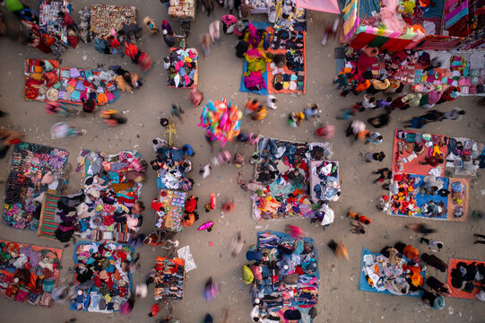 Narayanganj, Bangladesh - 16 February 2021: Aerial view of a bustling marketplace, a vibrant tapestry of colors and movement, with people weaving through the stalls filled with goods.