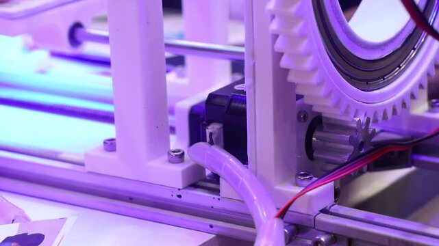 3d printed object with circular gear teeth being driven by a stepper motor. Mechanism of a motor and 3d printed part