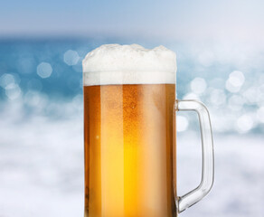 Mug of beer near sea, closeup. Refreshing summer drink