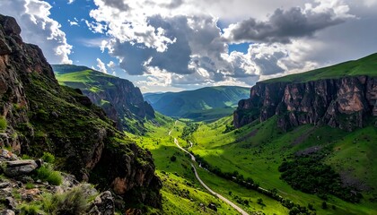 Vast canyon landscape with lush green valley under a dramatic sky