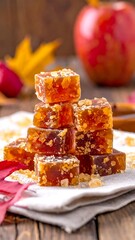 Stacked amber jelly candies with apple, leaves, and cinnamon detail