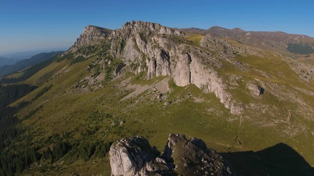 Strungile Mici Aerial Pull Back Revealing Saua Strunga Refuge and Omu Peak on Bucegi Plateau During Golden Hour