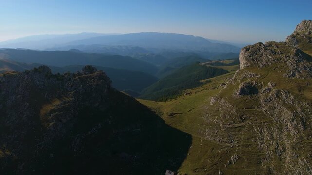 Saua Strunga Aerial Flyover Between Strungile Mici and Mari Revealing Rucar Bran Valley and Piatra Craiului Panorama