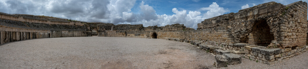 Panoramic view of ancient ruins under a cloudy sky from Segobriga, Spain