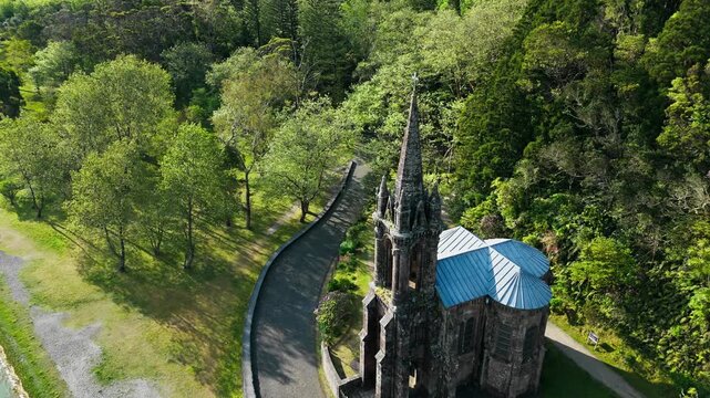Aerial view of Capela de Nossa Senhora das Vitorias set among tall trees in Azores