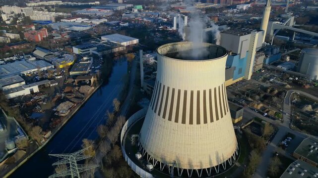 Hard Coal power plant cooling tower emitting steam. Smooth aerial view drone