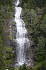 Obraz premium Waterfall in the Austrian Alps. Mountain and forest landscape.