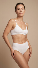 Model poses confidently in white lingerie showcasing body care and natural beauty in a neutral setting promoting wellness and self care