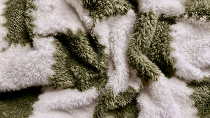 soft fluffy green white striped fleece texture macro closeup cozy blanket folds inviting tactile background for wallpaper design © Arthur