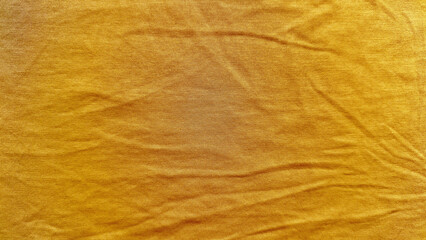 vibrant mustard yellow corduroy fabric texture closeup showcasing soft wrinkles and subtle sheen for elegant wallpaper or design banner background