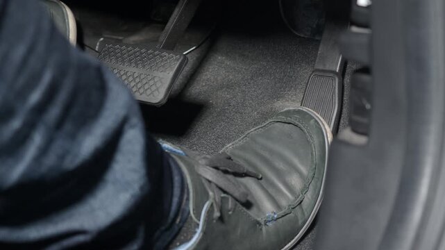 Accelerate and Brake. Foot pressing foot pedal of a car to drive ahead. Man driving car by pressing Accelerator and Brake in car. Driver driving the car by pushing accelerator pedals of the car inside