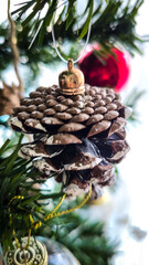 Close-up of Festive Pinecone and Glitter Star Ornaments on a Christmas Tree