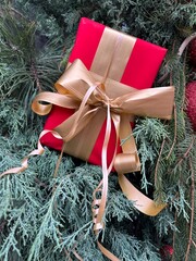 Christmas tree branches with red balls and a gift