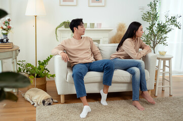 Fototapeta premium Quarrel Between Asian Couple Revealing Issues of Infidelity and Emotional Distance in a Cozy Setting