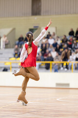 Female roller skater balancing on one leg performing artistic routine