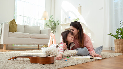 Mom and Daughter Enjoy Reading and Playing in Their Cozy Home During the Afternoon