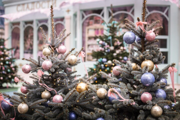 Christmas trees decorated with Christmas baubles on the city streets
