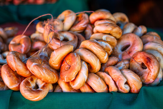 Fresh Polish bagels stacked on market stall traditional street bakery food closeup european cuisine vendor display