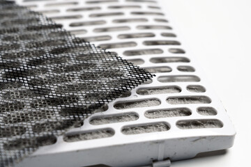 Mesh and cellular elements of the ventilation system on white surface. Clogged filtration material