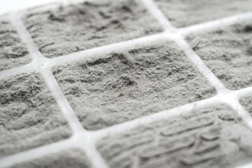 Dust covered filter surface with fiber structure and grid pattern. Air pollution buildup. Clogged filtration material