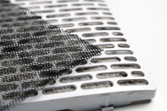 Mesh and cellular elements of the ventilation system on white surface. Clogged filtration material